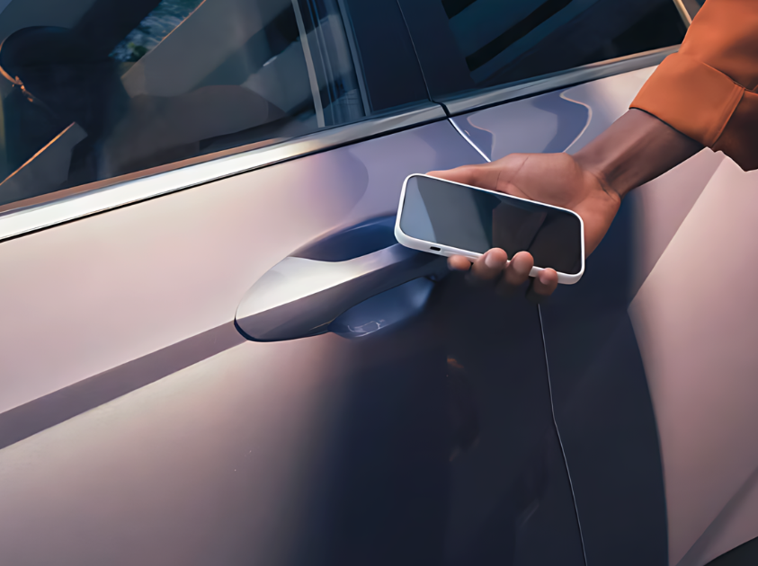 Close-up of a person using a smartphone to unlock a Hyundai vehicle with Hyundai Digital Key 2